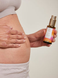 a model applying the natural body oil by khadi