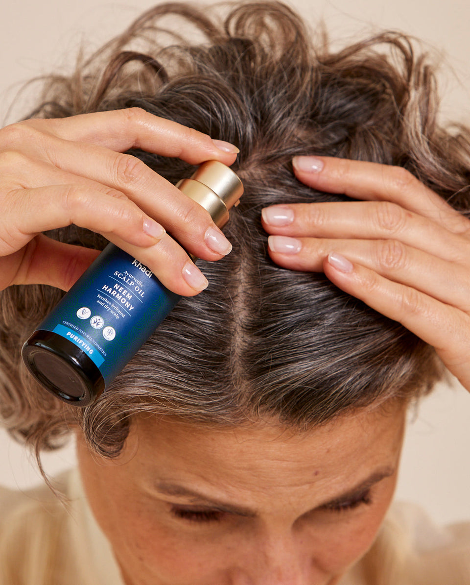 Image of Neem Hair Oil application, hand model by khadi